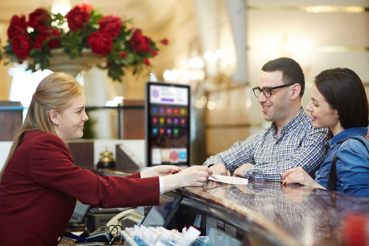 two guests checking into a hotel