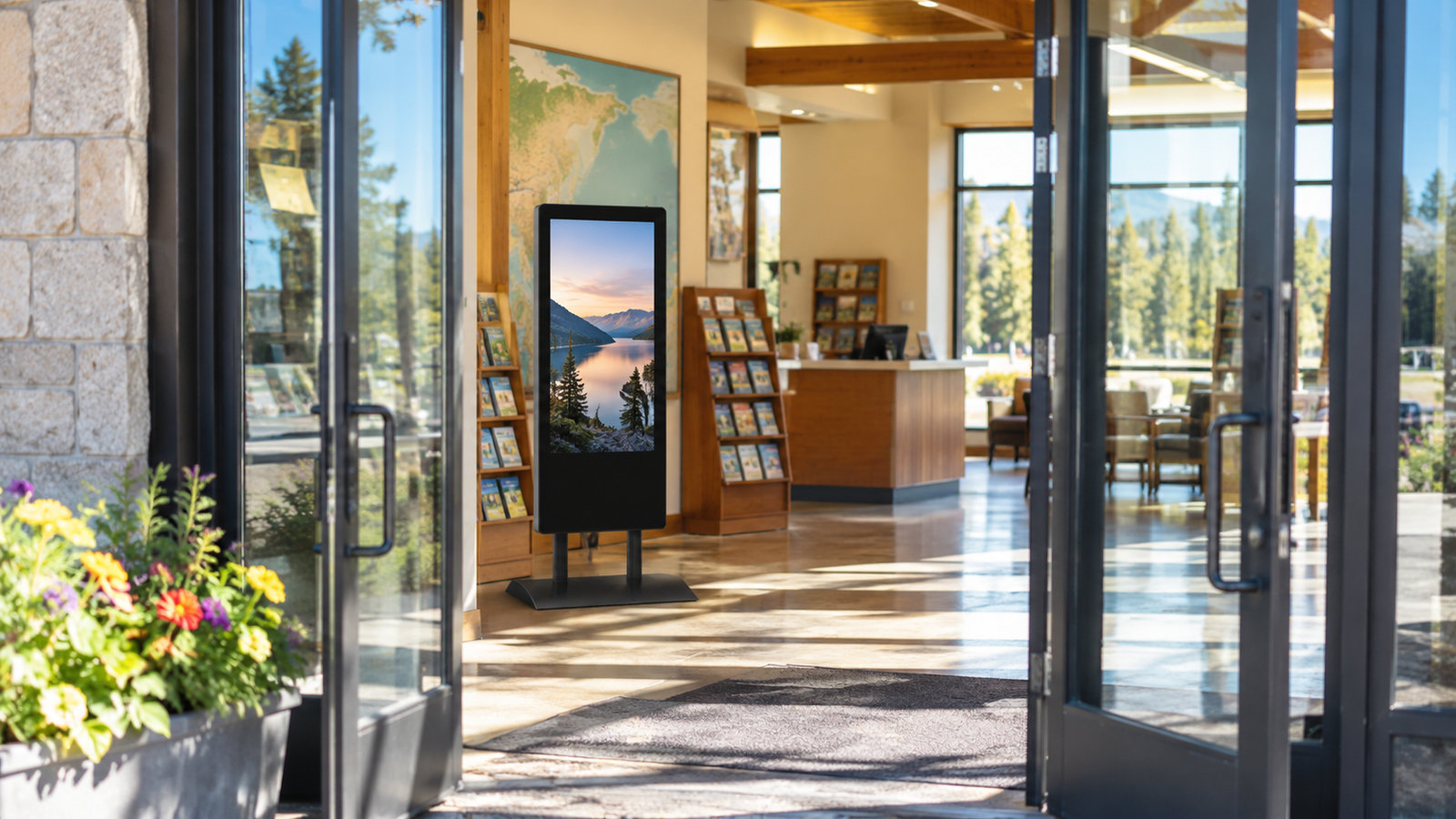 Open glass doors of a visitor center with a HootBoard AirX kiosk glowing inside