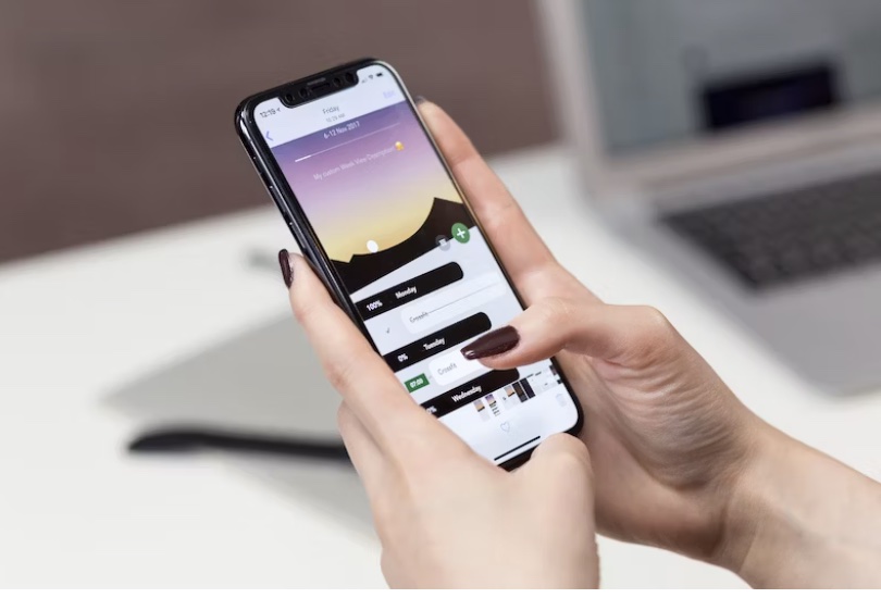 two hands holding a mobile device and using an app