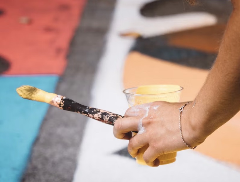 hands holding a paint brush